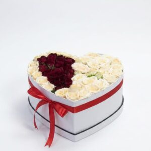 Peach spray roses with red roses inside the heart box